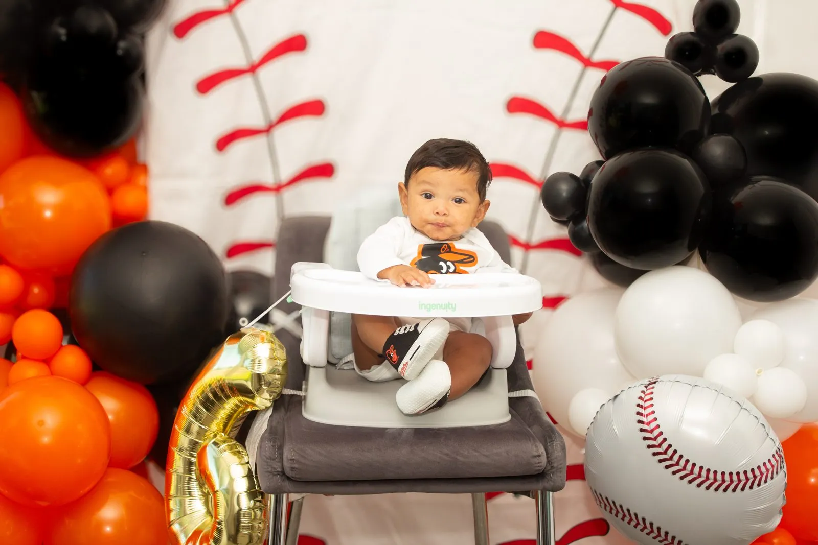 Baseball themed first birthday setup with balloons