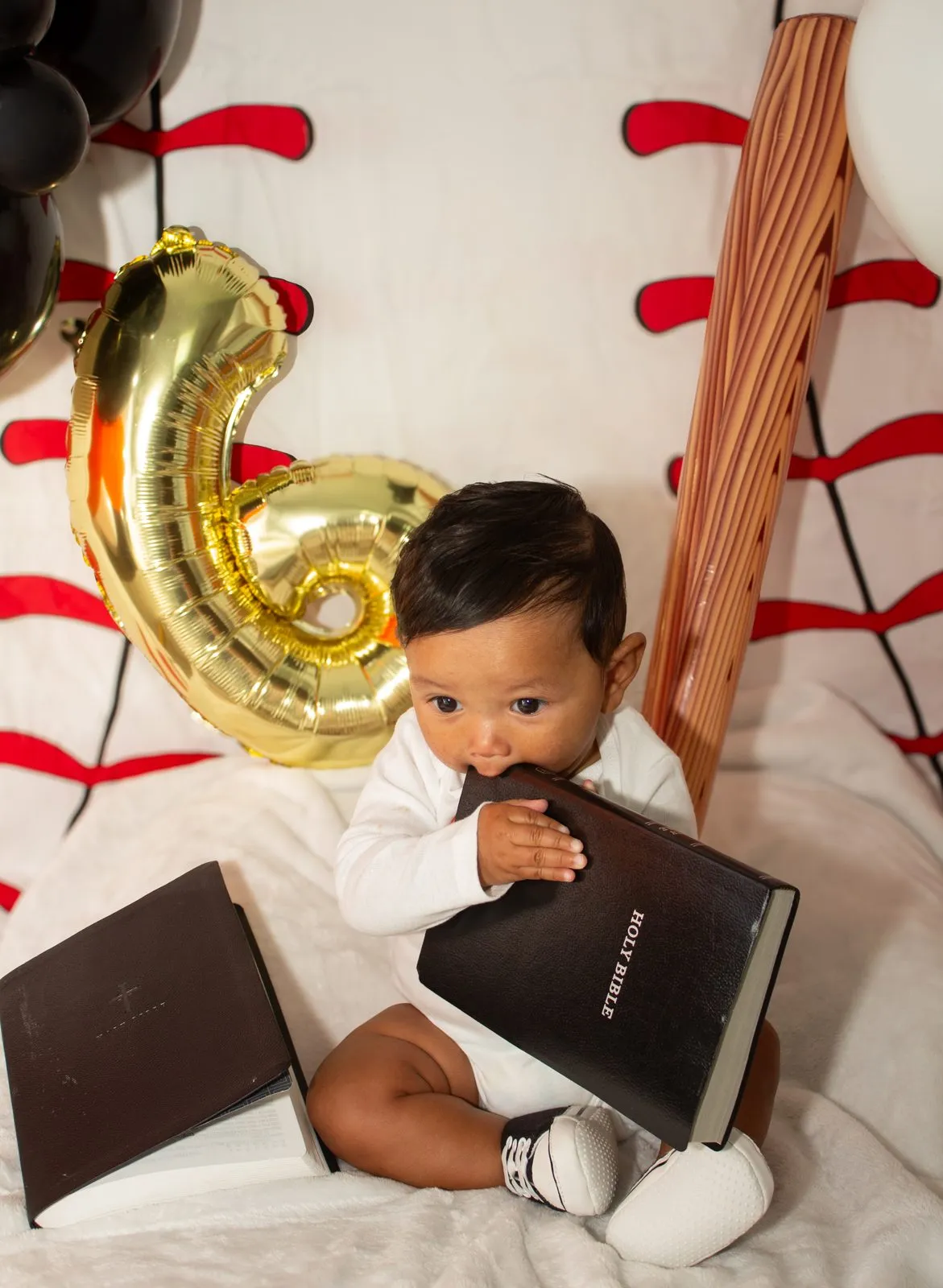 Baby at a sixth month milestone shoot with books