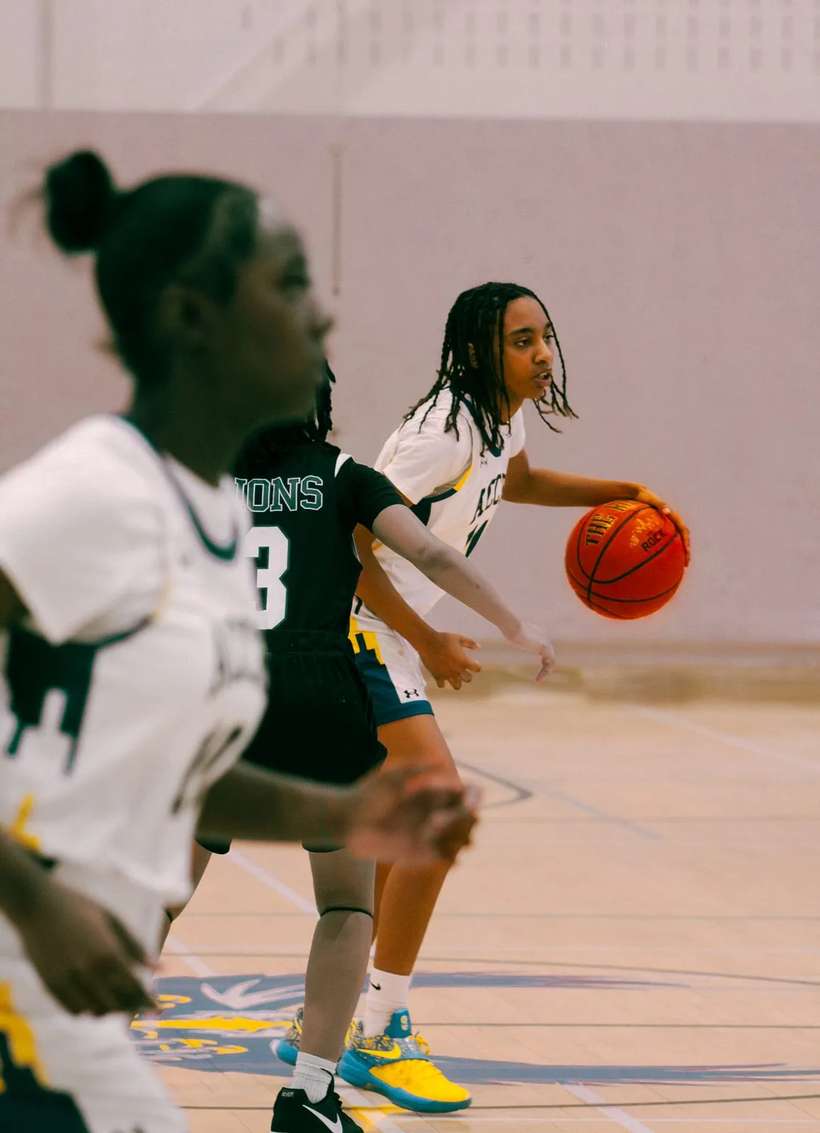 Girls basketball game action on the court